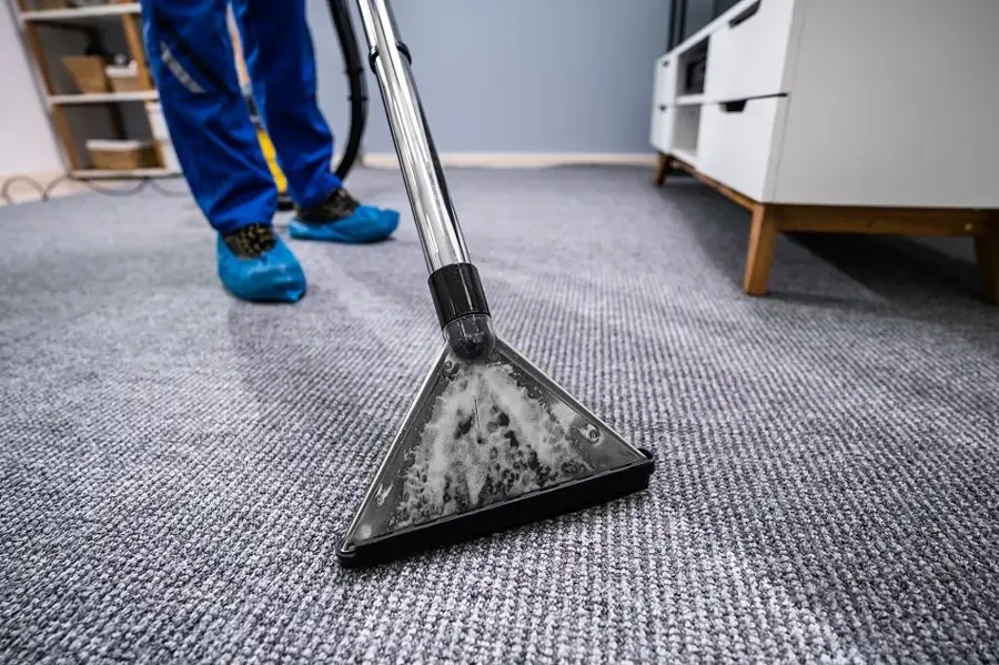 Extraction wand pulling standing water out of carpet in Cedar Park